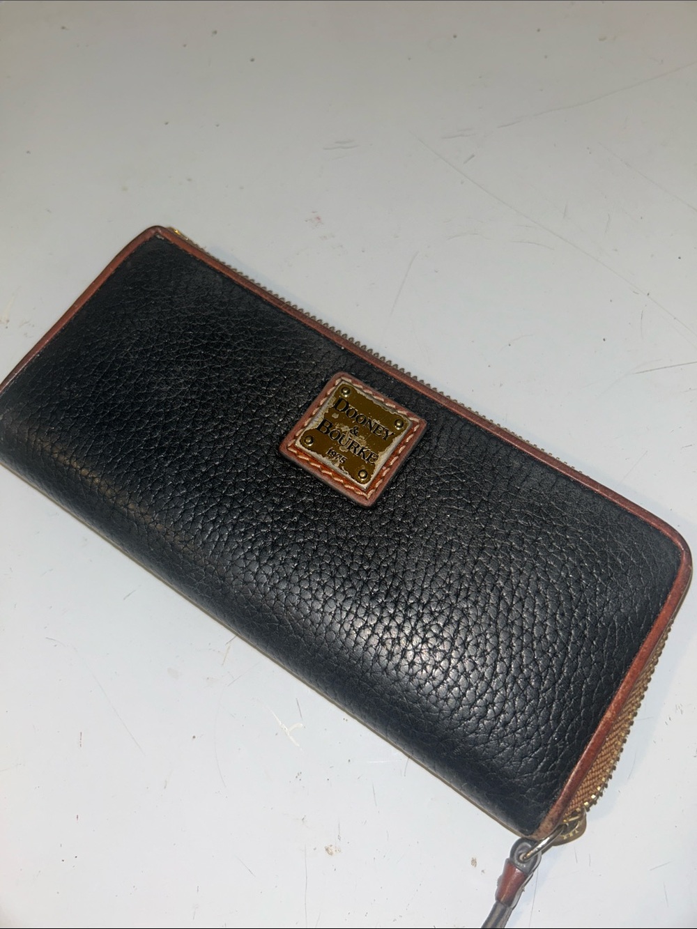 Dooney & Bourke Black Pebbled Leather Zip Wallet with Brown Trim